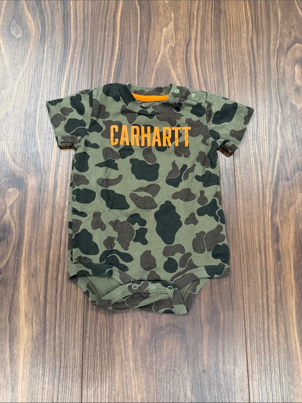 Carhartt Olive and Black Camo Baby Bodysuit with Orange Logo